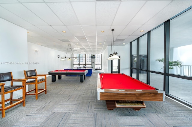 recreation room with carpet flooring, pool table, a wall of windows, and a paneled ceiling