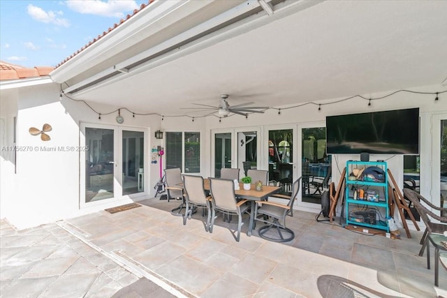 view of patio featuring french doors, outdoor dining area, and a ceiling fan