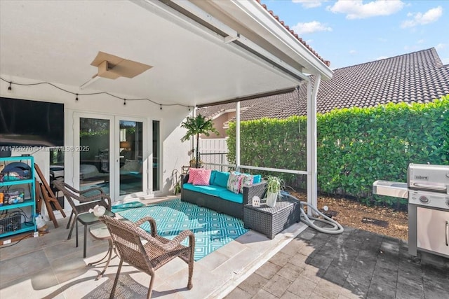 view of patio / terrace featuring french doors, fence, and an outdoor living space