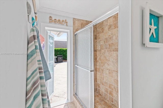 bathroom featuring a stall shower and crown molding