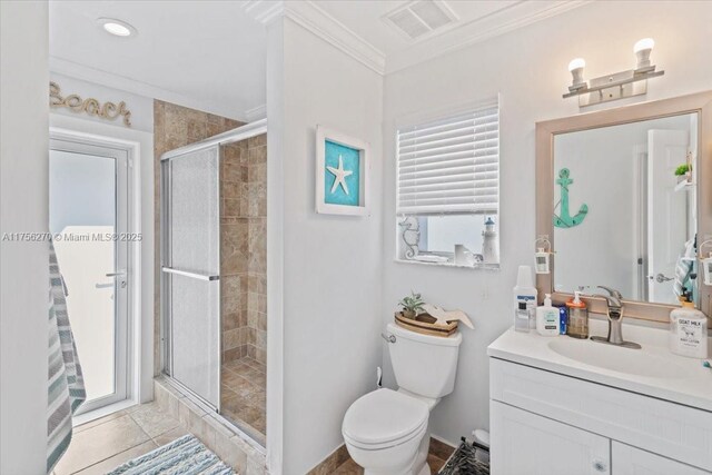 full bathroom with toilet, vanity, visible vents, a stall shower, and crown molding