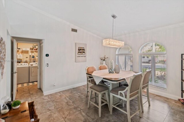 dining space with washing machine and dryer, visible vents, crown molding, and baseboards