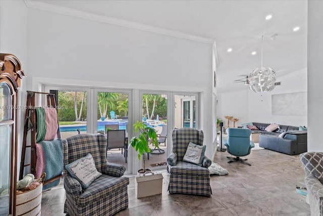 living area featuring a towering ceiling, an inviting chandelier, ornamental molding, and recessed lighting