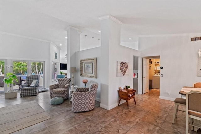 living area featuring high vaulted ceiling, washer / dryer, visible vents, and baseboards