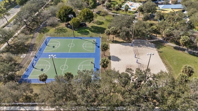 view of sport court featuring community basketball court, fence, and a lawn