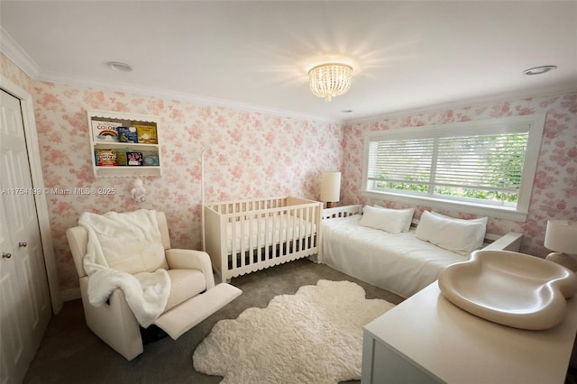 bedroom featuring wallpapered walls, ornamental molding, and a notable chandelier