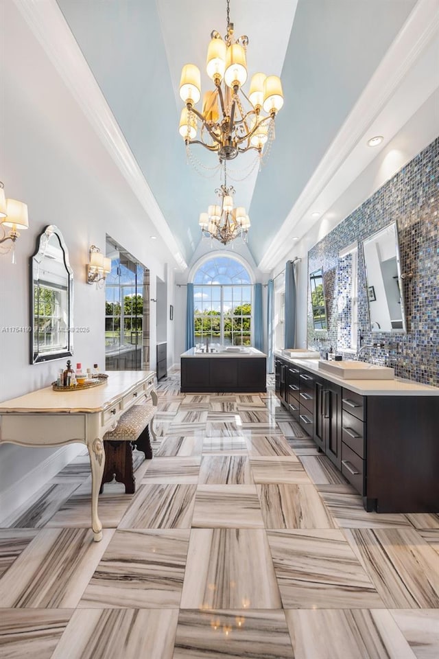 bathroom with double vanity, decorative backsplash, a bathing tub, an inviting chandelier, and high vaulted ceiling