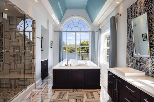 bathroom featuring a bath, a stall shower, backsplash, and vanity