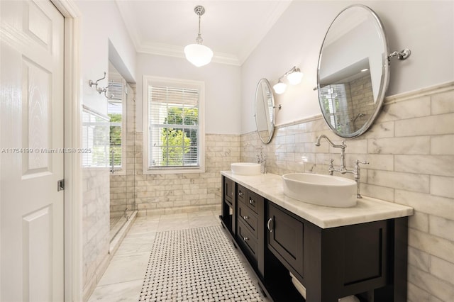 full bathroom featuring ornamental molding, a sink, tile walls, and a shower stall