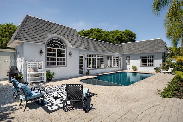 outdoor pool featuring a patio area and a grill