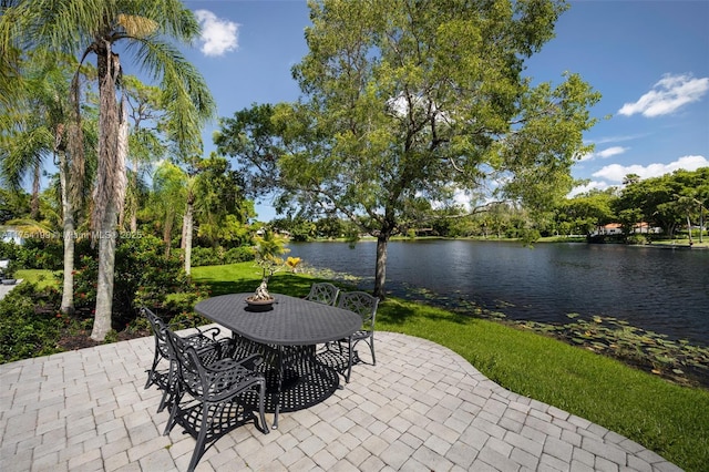 view of patio / terrace with outdoor dining space and a water view