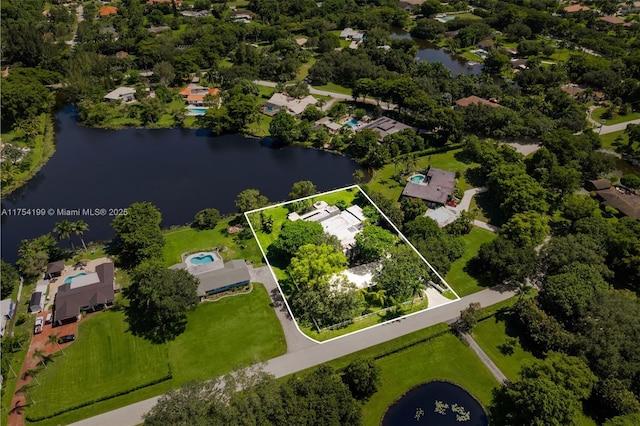 drone / aerial view featuring a water view and a residential view