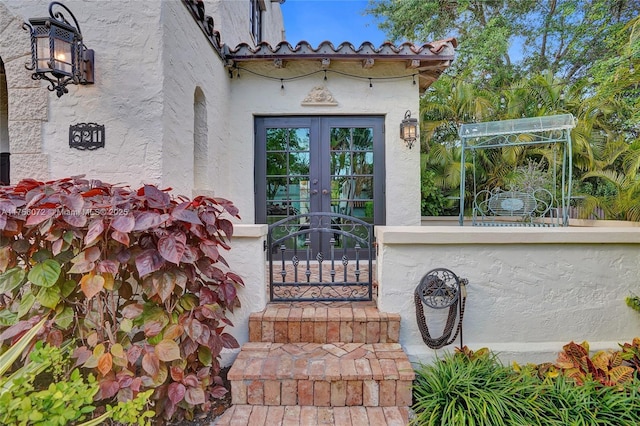 doorway to property with french doors and stucco siding