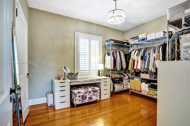 walk in closet with wood-type flooring