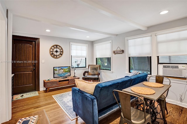 living area featuring beam ceiling, cooling unit, recessed lighting, light wood-type flooring, and baseboards