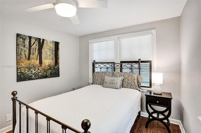 bedroom featuring a ceiling fan, baseboards, and wood finished floors