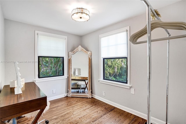 home office featuring baseboards and wood finished floors