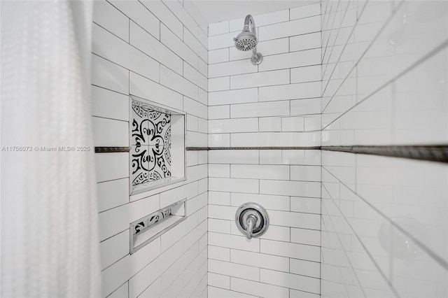 bathroom with tiled shower