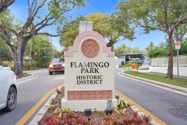 community / neighborhood sign featuring fence