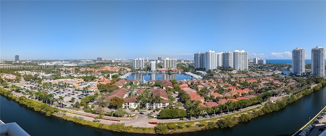 drone / aerial view featuring a view of city and a water view