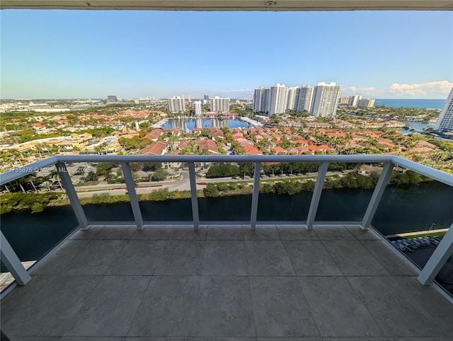 balcony featuring a view of city and a water view