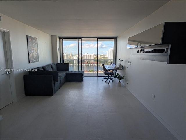 living area featuring expansive windows and baseboards