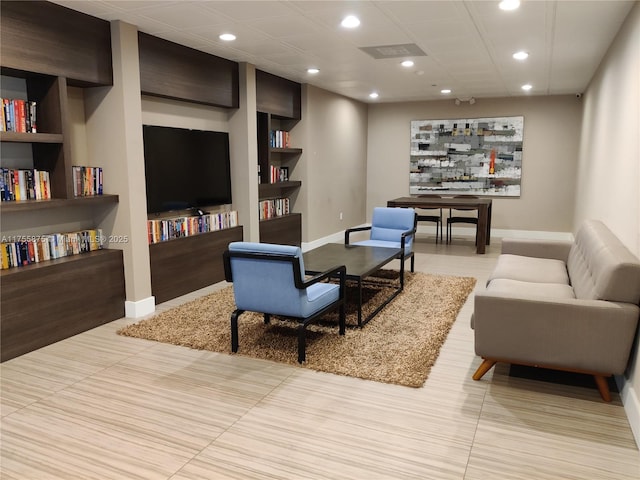 living area with built in shelves, recessed lighting, and baseboards