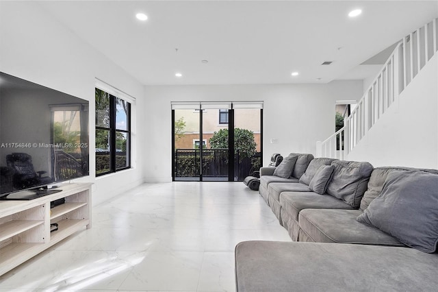 living area featuring recessed lighting, marble finish floor, and visible vents