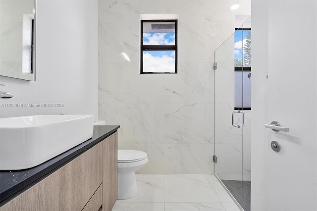 full bath with marble finish floor, vanity, a marble finish shower, and toilet