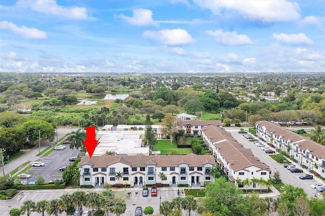 drone / aerial view with a residential view and a water view