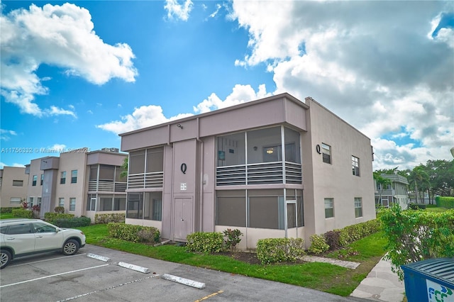 view of property featuring uncovered parking