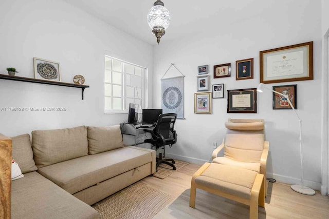 interior space with baseboards and wood finished floors