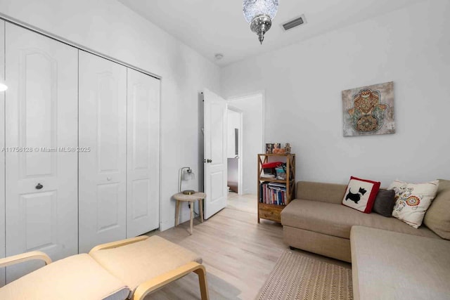 living area with light wood-type flooring and visible vents