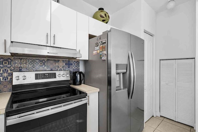 kitchen with stainless steel appliances, light countertops, white cabinets, and under cabinet range hood