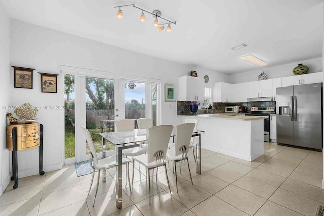 dining space featuring light tile patterned floors and french doors