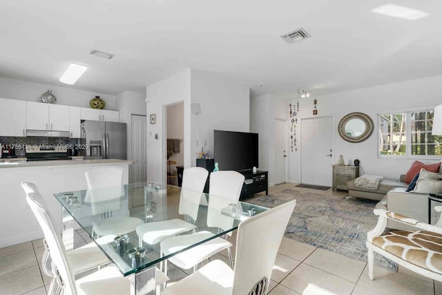 dining room featuring light tile patterned flooring and visible vents