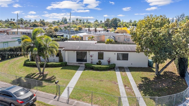 view of property with a fenced front yard, a residential view, a gate, a front yard, and stucco siding