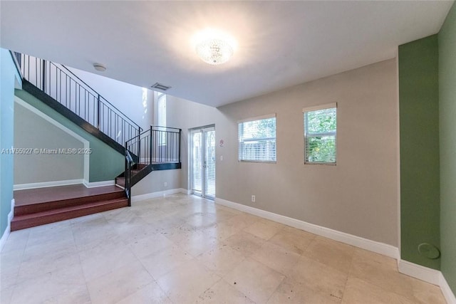 interior space featuring stairway, baseboards, and visible vents