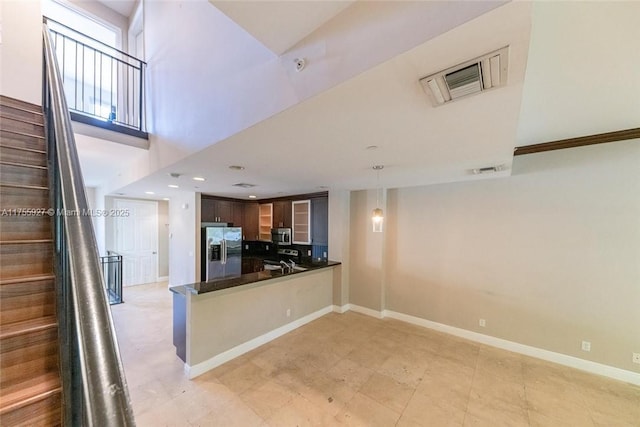 kitchen featuring dark countertops, baseboards, visible vents, and stainless steel appliances