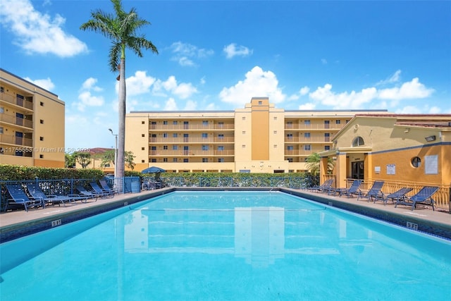 community pool featuring a patio area and fence