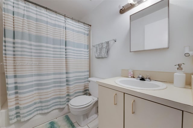 bathroom featuring shower / tub combo, vanity, and toilet