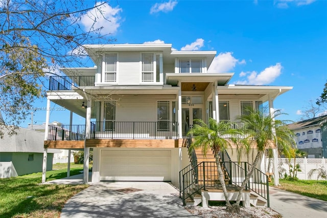 view of front facade with a garage, stairs, a porch, and concrete driveway