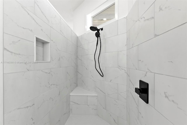 full bathroom featuring tiled shower