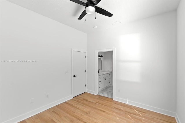 unfurnished room featuring ceiling fan, light wood-type flooring, and baseboards