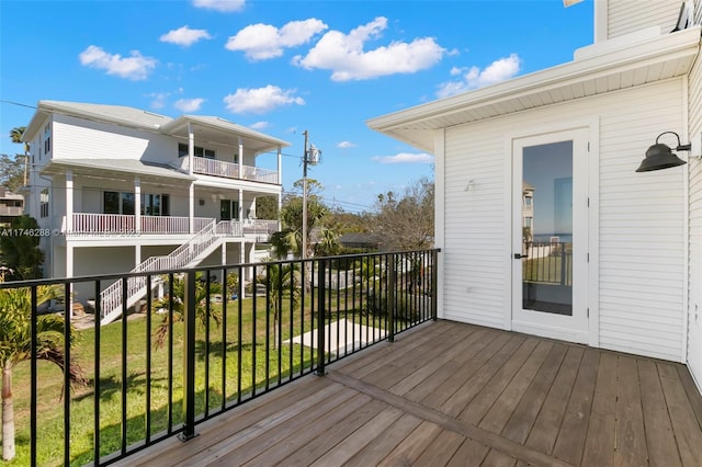 wooden terrace featuring a lawn