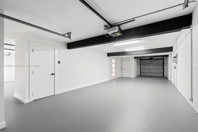 garage with baseboards and a garage door opener