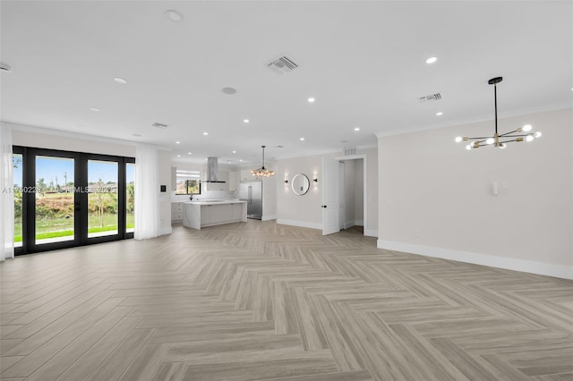 unfurnished living room with baseboards, recessed lighting, visible vents, and an inviting chandelier