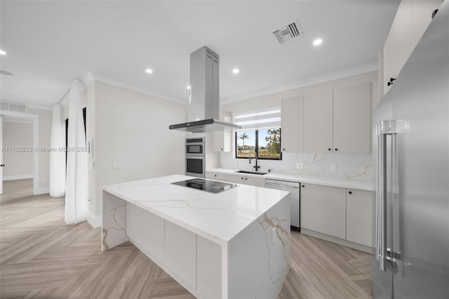 kitchen featuring visible vents, a kitchen island, island exhaust hood, stainless steel appliances, and a sink