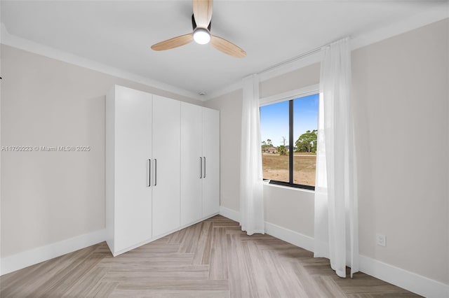 unfurnished bedroom featuring a ceiling fan, a closet, and baseboards