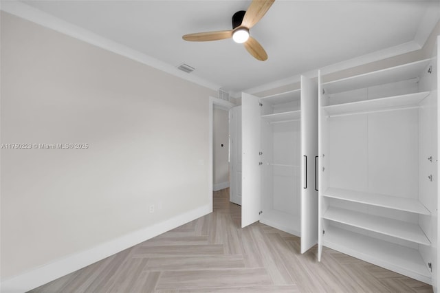 unfurnished bedroom with ceiling fan, multiple closets, visible vents, and baseboards